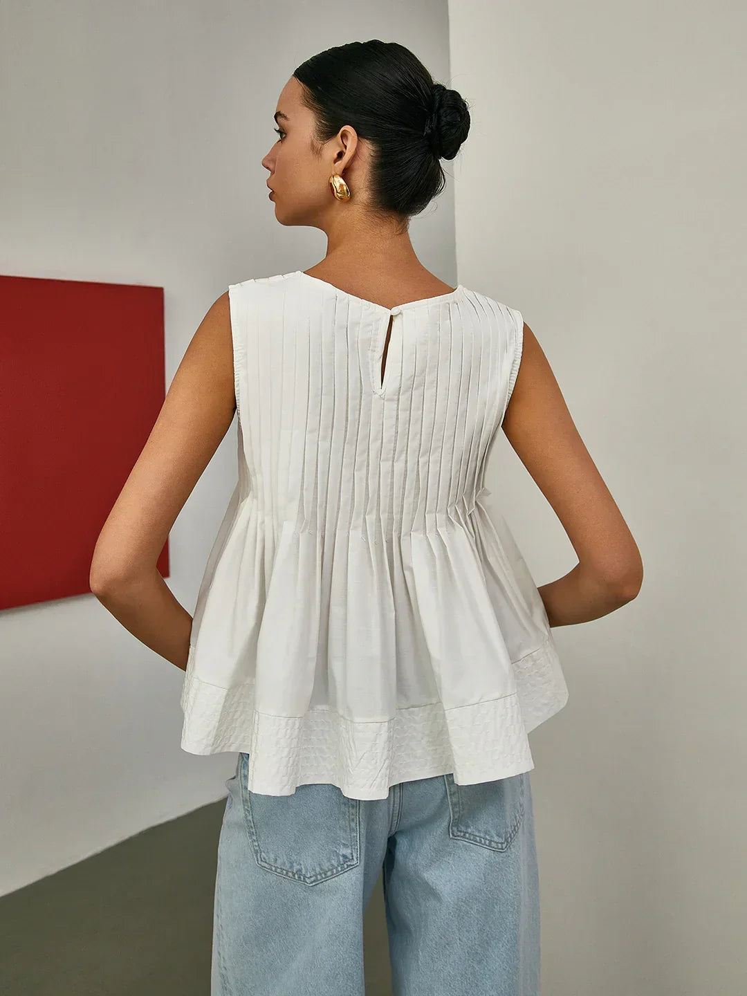 Blusa sin Mangas con Peplum Plisado