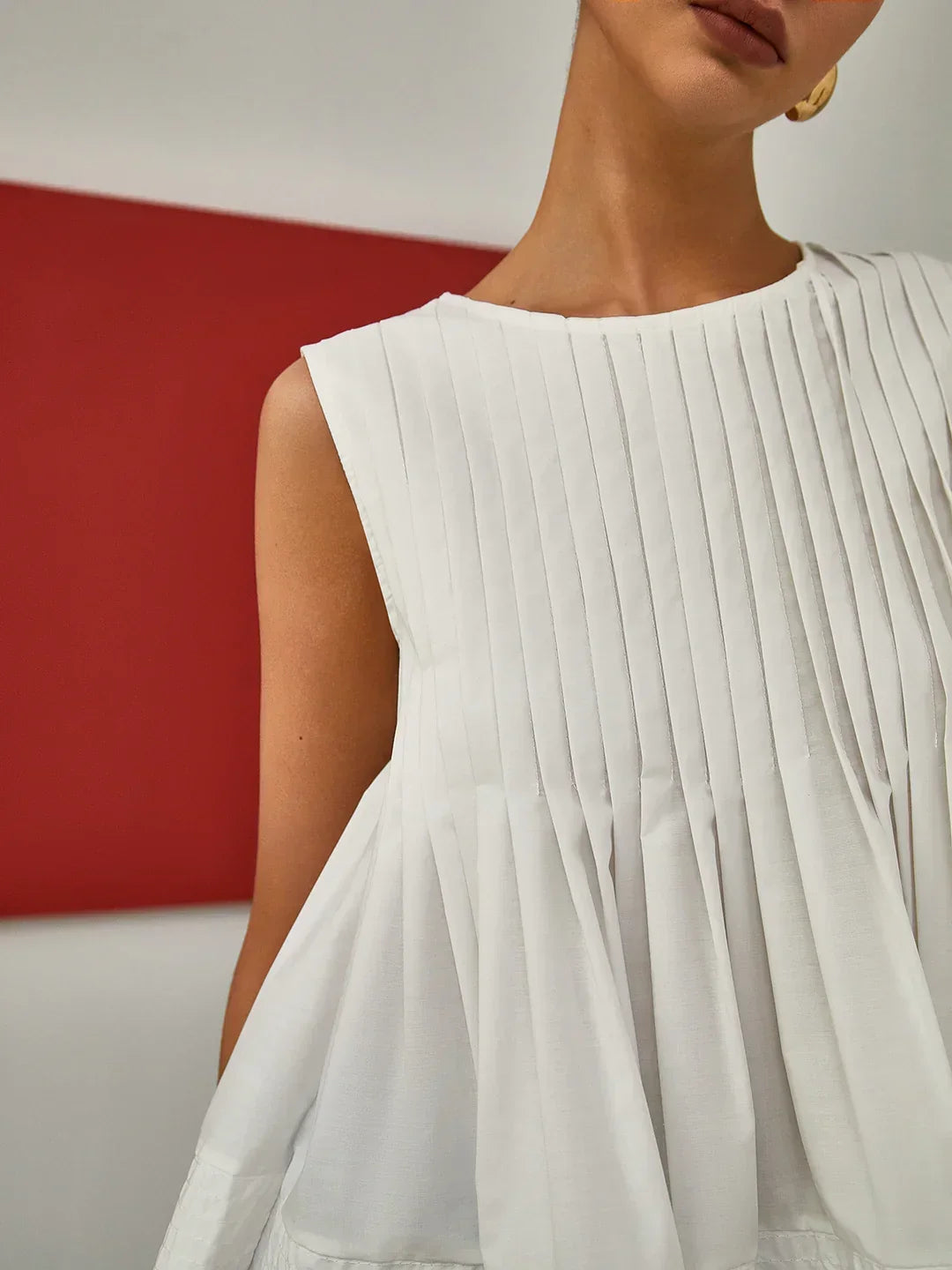 Blusa sin Mangas con Peplum Plisado
